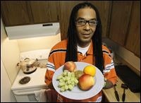 vegetarian Ishmael Shakur Ishmael Shakur holds a plate of fruit at his home in Toledo.